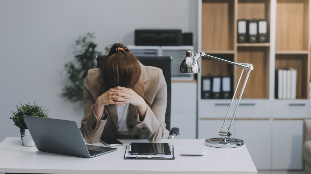 depressed women sitting in an office