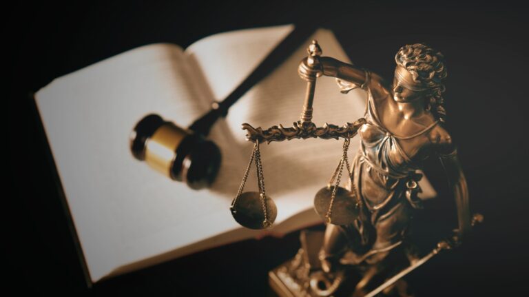 Lady Justice statue and books in background