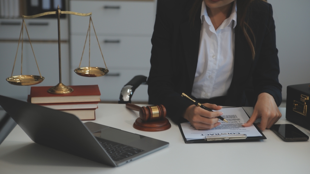 woman lawyer working with laptop and reading contract documents
