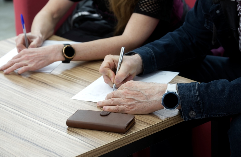 Adult man and woman fill out the forms