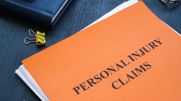 A stack of papers with personal injury claims on the table