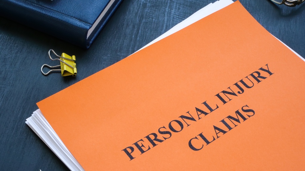 A stack of papers with personal injury claims on the table