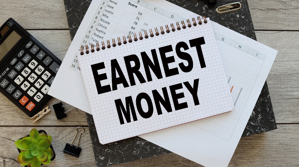 Earnest money open notepad with text on financial charts