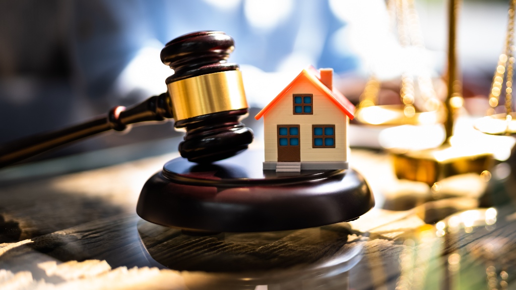 Judge's gavel and wooden house model