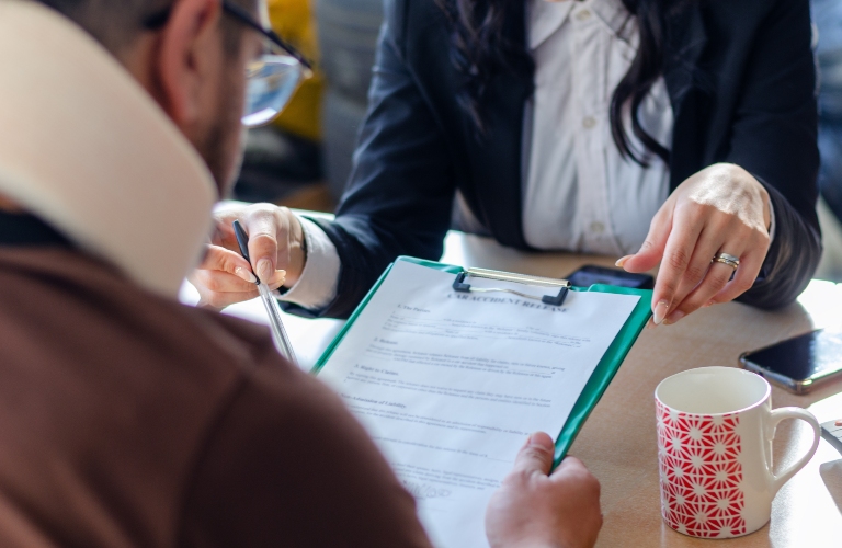 Man signing a document paper