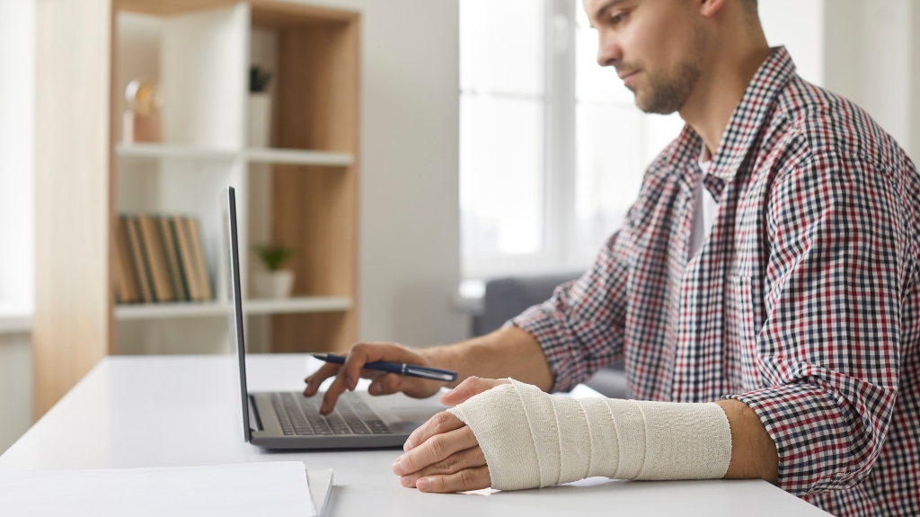 Сoncentrated young man with sprained ligament in his arm