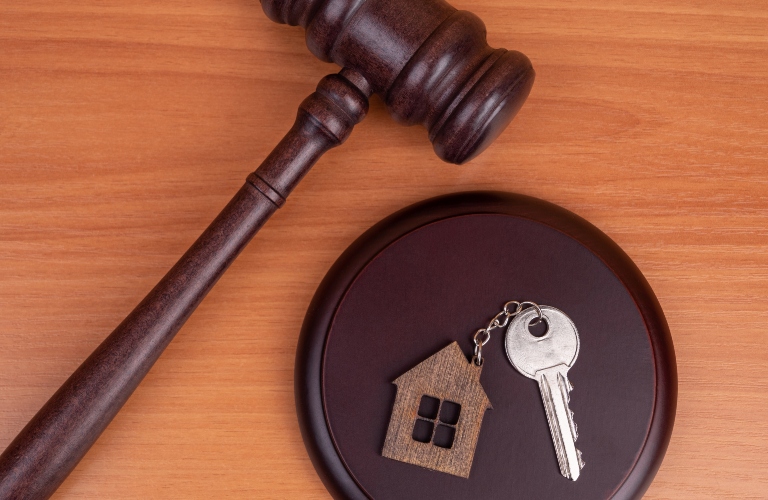 Judge gavel and key chain in shape of two splitted part of house