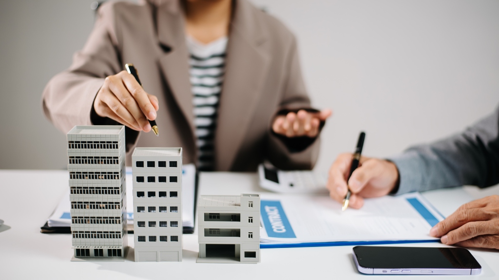 Real estate agent and investor discussing commercial property contract